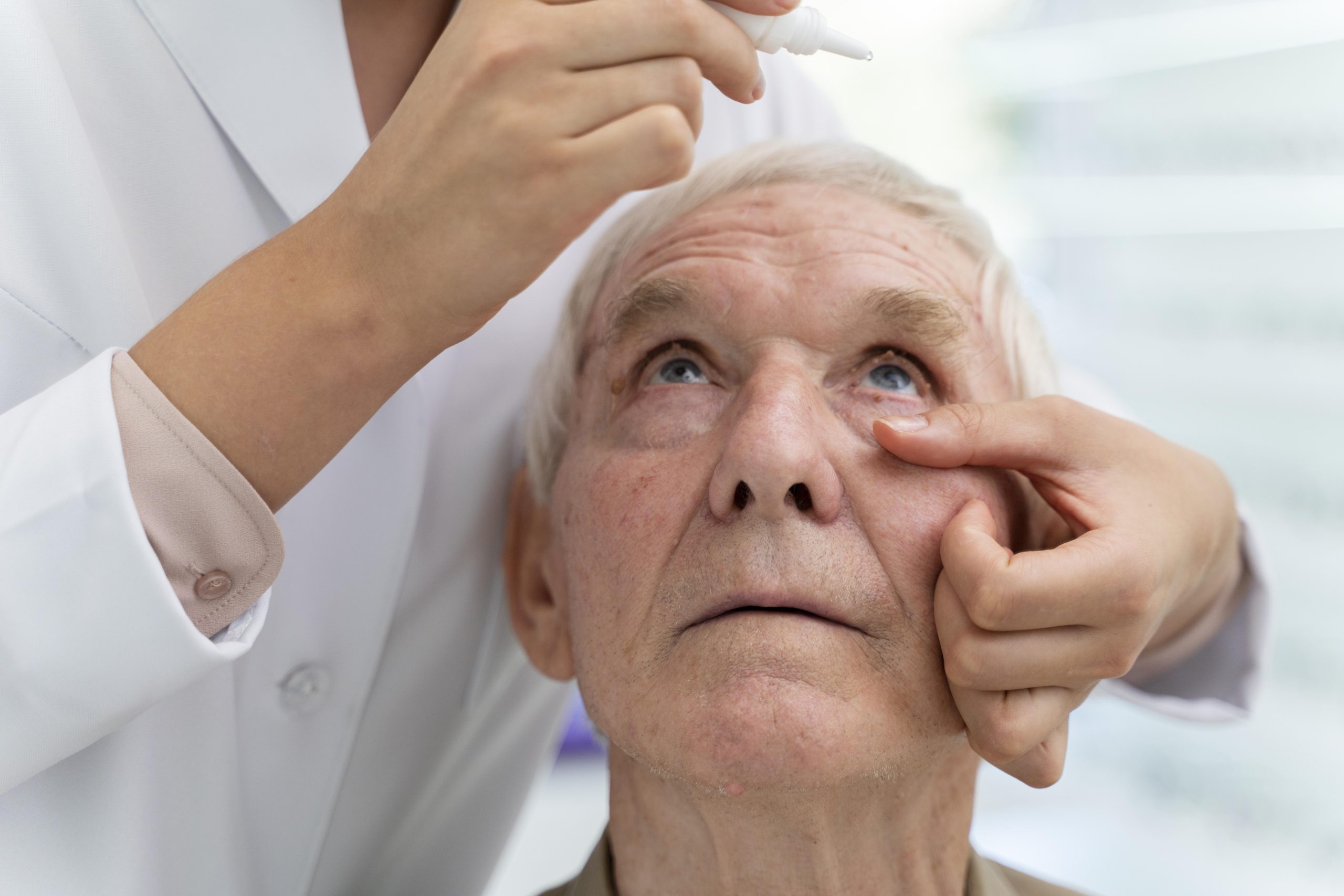 doctor-pouring-some-eye-drops-patient doctor-pouring-some-eye-drops-patient