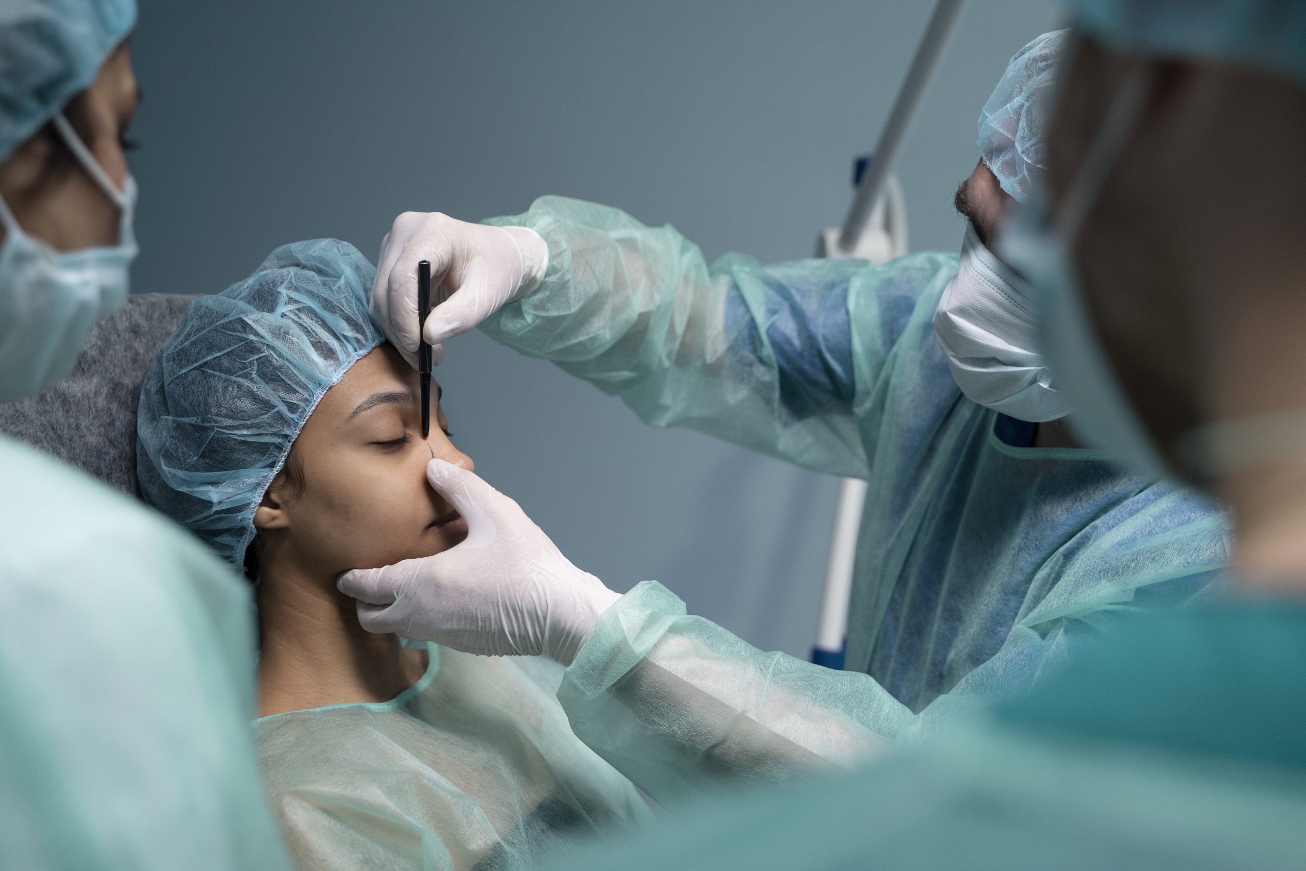 side-view-doctor-checking-patient-before-rhinoplasty side-view-doctor-checking-patient-before-rhinoplasty